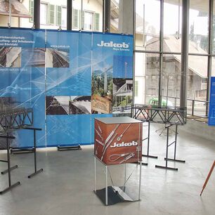 Sistema de exposición GERY en formato 100×250 cm con gráfico textil impreso de alta calidad – presentación de marca llamativa para Jakob