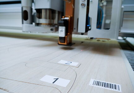 Label Module on a eurolaser CO₂ laser cutting machine applying a label to material to enable tracking in subsequent production processes